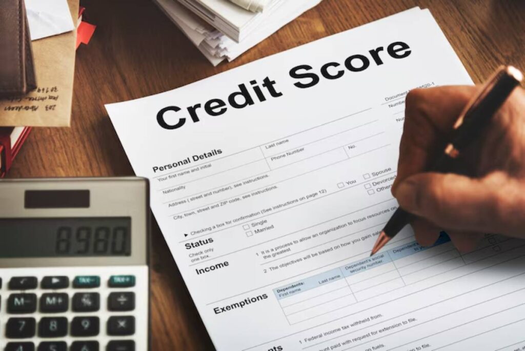 A hand writing on a Credit Score form with a calculator displaying 8980 in the foreground, surrounded by papers and a wallet.