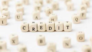 Close-up of scattered letter blocks with the word CREDIT clearly highlighted in the center, symbolizing finance and credit concepts.