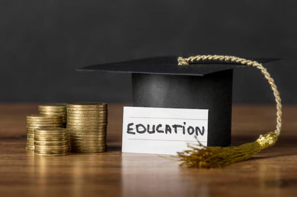 A graduation cap labeled EDUCATION next to stacks of coins, symbolizing the financial aspect of higher education.