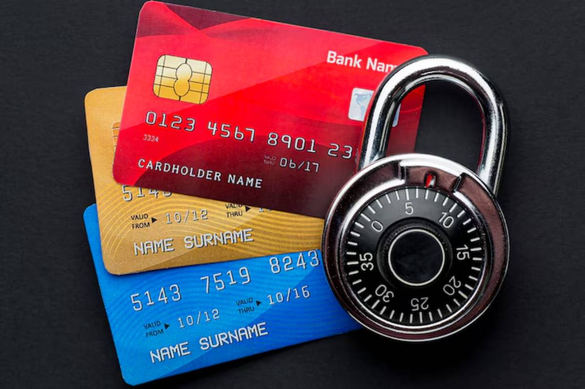  Three credit cards stacked with a combination lock, symbolizing security and protection of personal financial information.